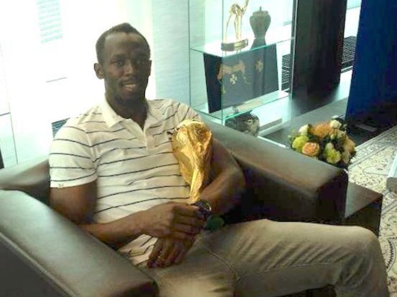 Usain Bolt Hold The Official FIFA World Cup In Brazil (PHOTO)