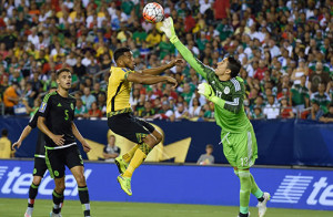 Mexico's goalkeeper Guillermo Ochoa (R) knocks the ball away from Jamaica's Adrian Mariappa during the 2015 CONCACAF Gold Cup final between Jamaica and Mexico in Philadelphia on July 26, 2015. AFP PHOTO/DON EMMERT